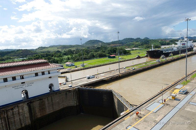 20101204_152447 D3S.jpg - Miraflores Locks, Panama Canal.  Oil tanker moving into the lock.  Note there are 2 channels, usually both flowing in the same direction.  Currently top tonnage is around 70,000.   Ships are now in service with tonnage over 300,000 tons and cannot go thru the canal.